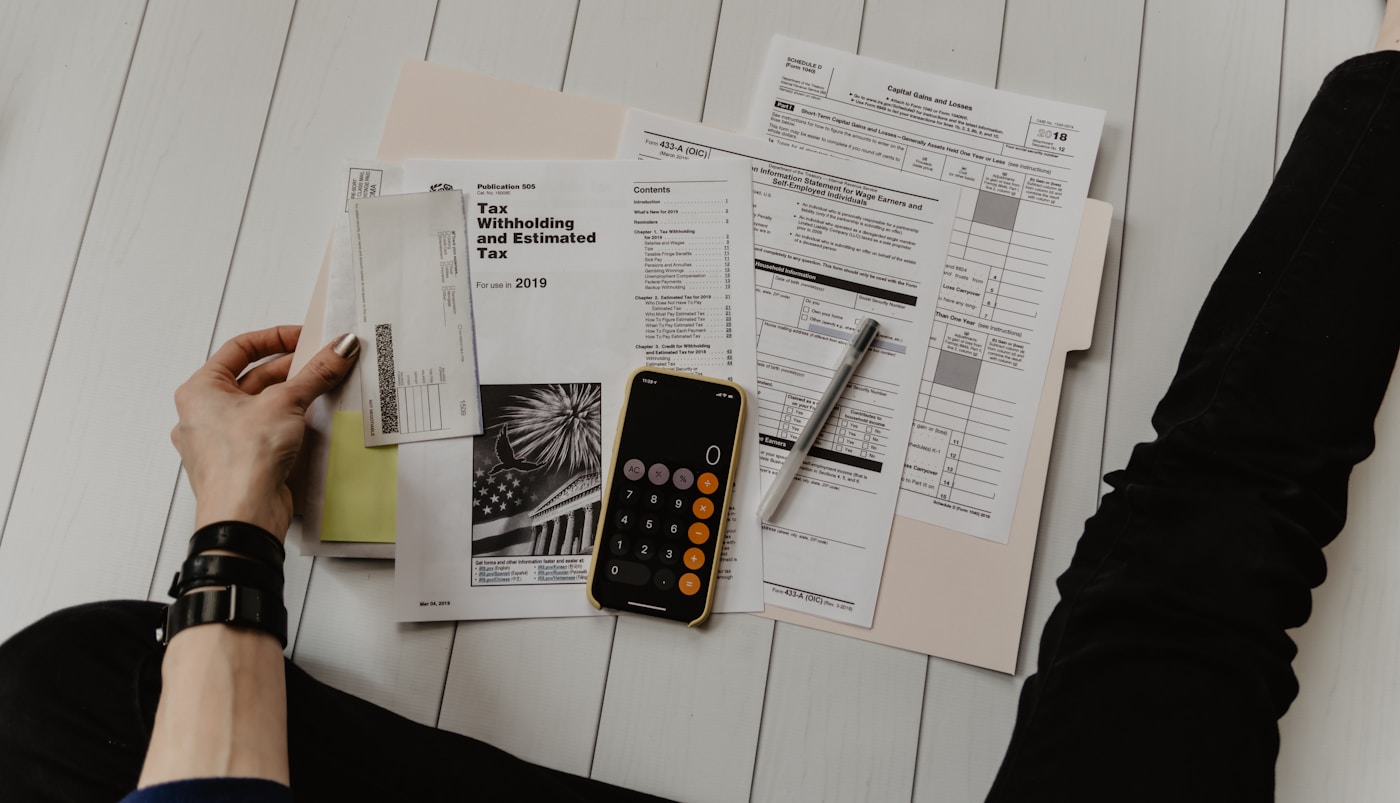 Desk with financial paperwork and laptop in grayscale